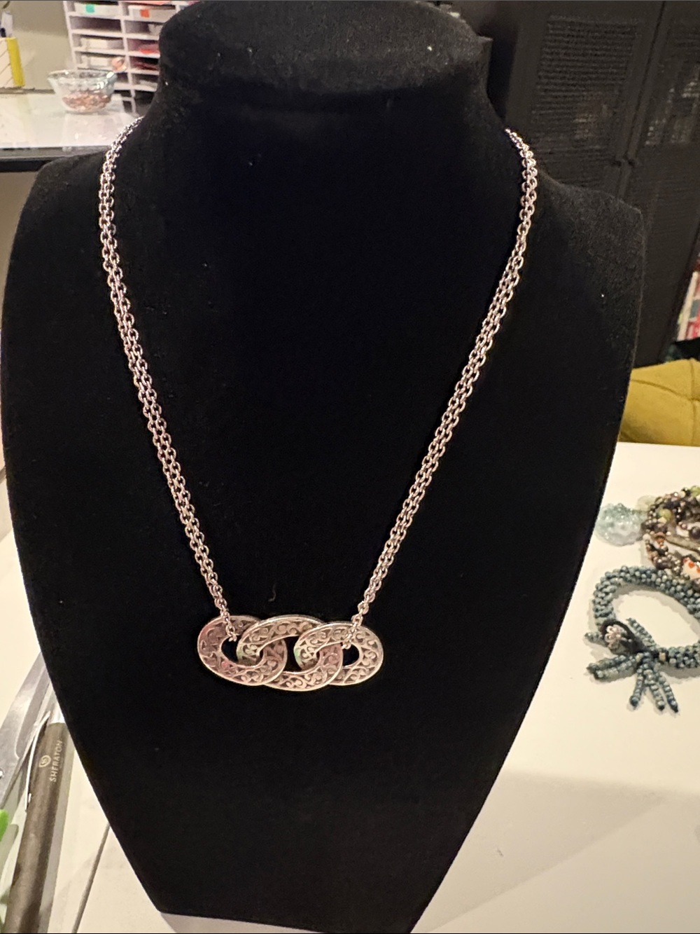 Lois Hill silver necklace with three interlocking rings.